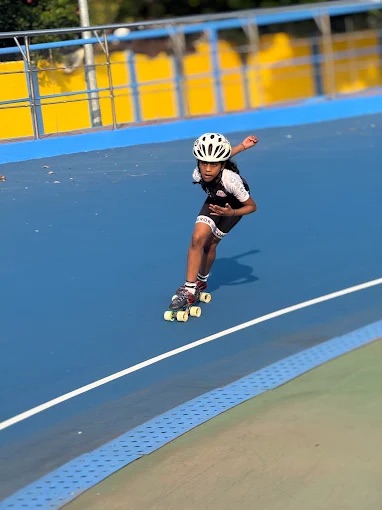A young Conqueror skater leaning into a turn on the track